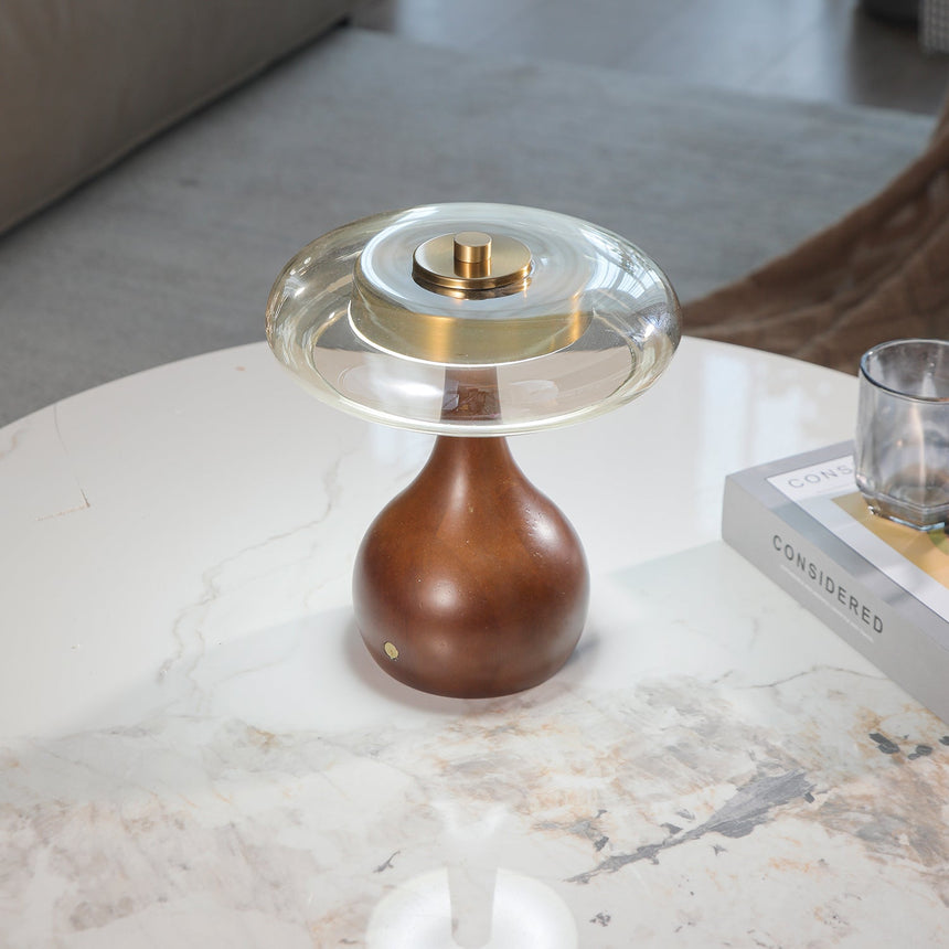 Close view of the turned walnut gourd base and its brass button