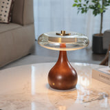 Small table lamp lit on a marble table in front of a pale sofa