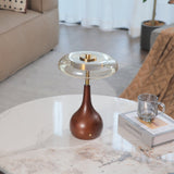 Small table lamp lit and seen from a low angle beside a glass