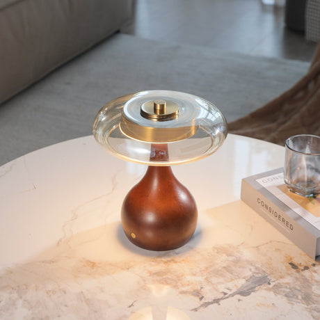Small table lamp lit in a warm tone on a marble side table