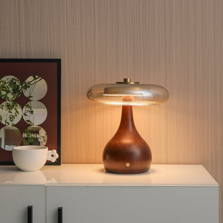 Small table lamp unlit on a white cabinet beside a framed print