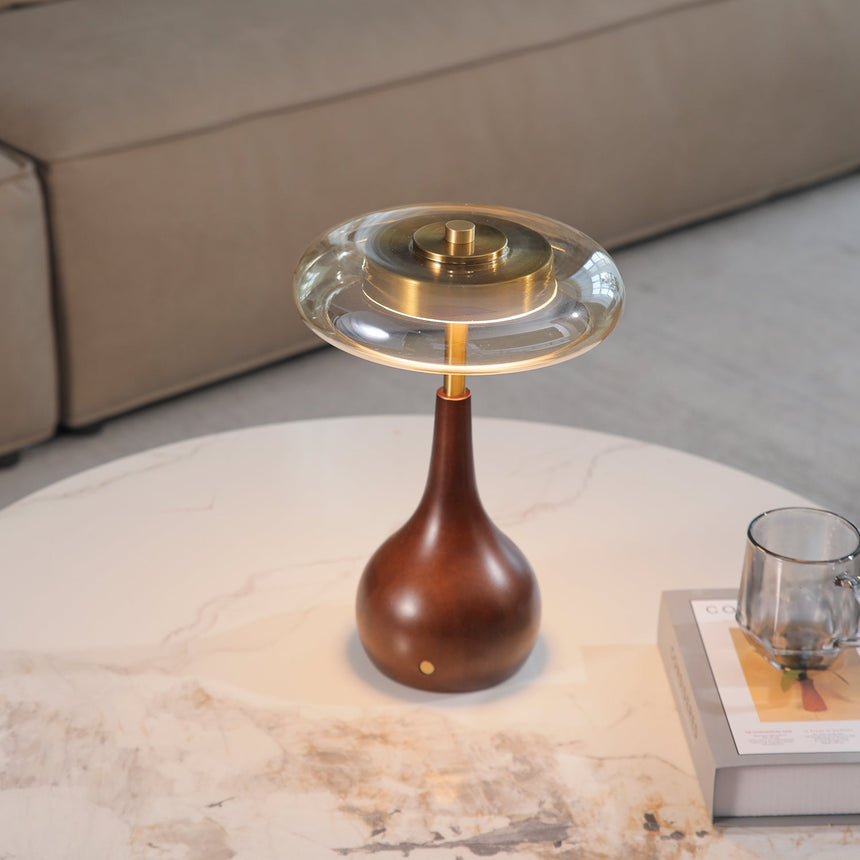 The taller small table lamp lit on a marble table by a sofa