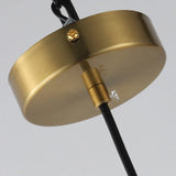 Close view of the brushed brass cap on top of the glass cylinder