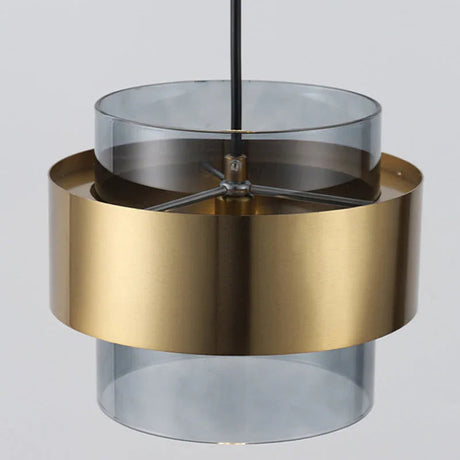 Close view of the brass band wrapped around a smoke gray glass cylinder