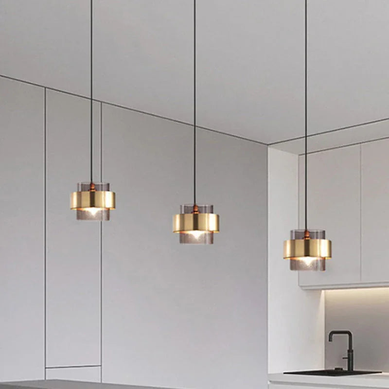Three banded pendants seen from below against a white ceiling