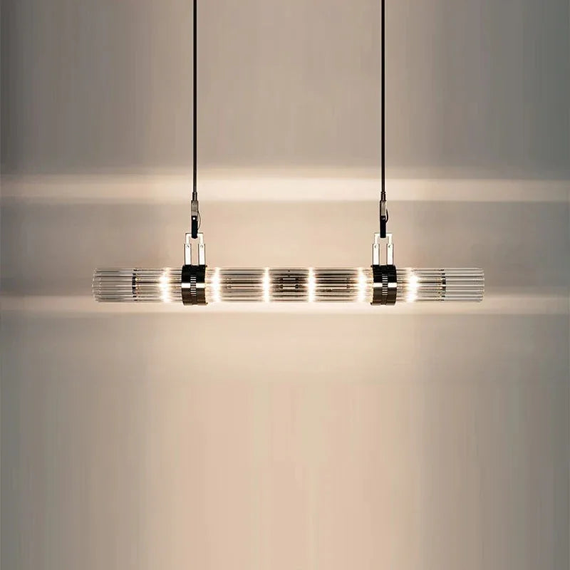 The lit row of smoked glass tubes seen close against a pale wall