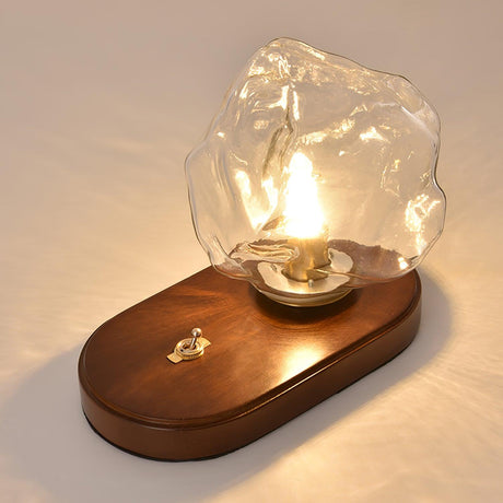 The glass ice form seen resting at an angle on the oval plinth
