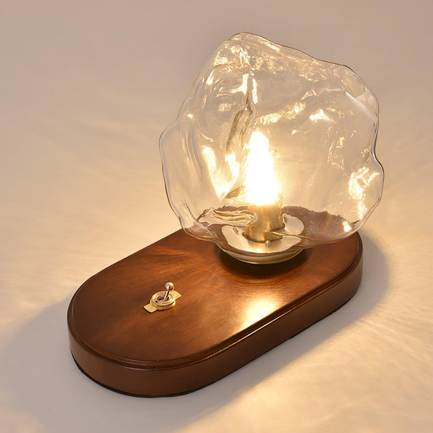 The glass ice form seen resting at an angle on the oval plinth