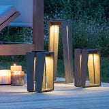 Three sizes lit on a timber deck beside candles under a pergola