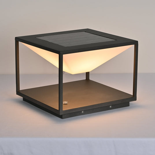 The cone diffuser lit warm inside the open frame on a pale surface