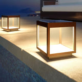 The frame lit on a mosaic pool edge at dusk with water below it