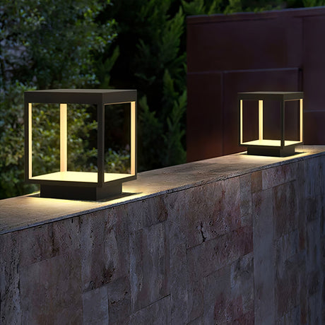 The frame glowing on a stone garden wall with a dark hedge behind