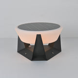 The dome lit warm above the faceted base on a pale studio table top