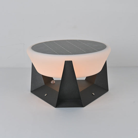 The dome lit warm above the faceted base on a pale studio table top
