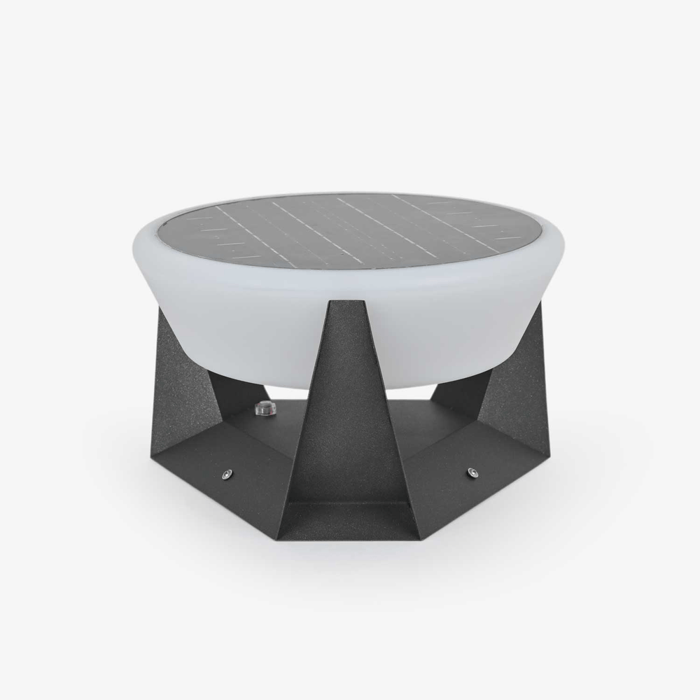 Round white dome light resting in a faceted dark base with sharp points