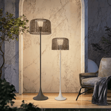 Two sizes lit against a pale marble wall beside an armchair and a throw