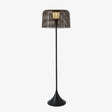 Tall slim floor lamp with a woven drum shade on a trumpet base