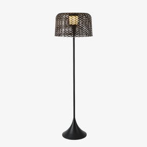 Tall slim floor lamp with a woven drum shade on a trumpet base
