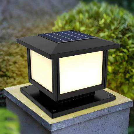 The panels glowing warm on a pillar with planting and a path behind