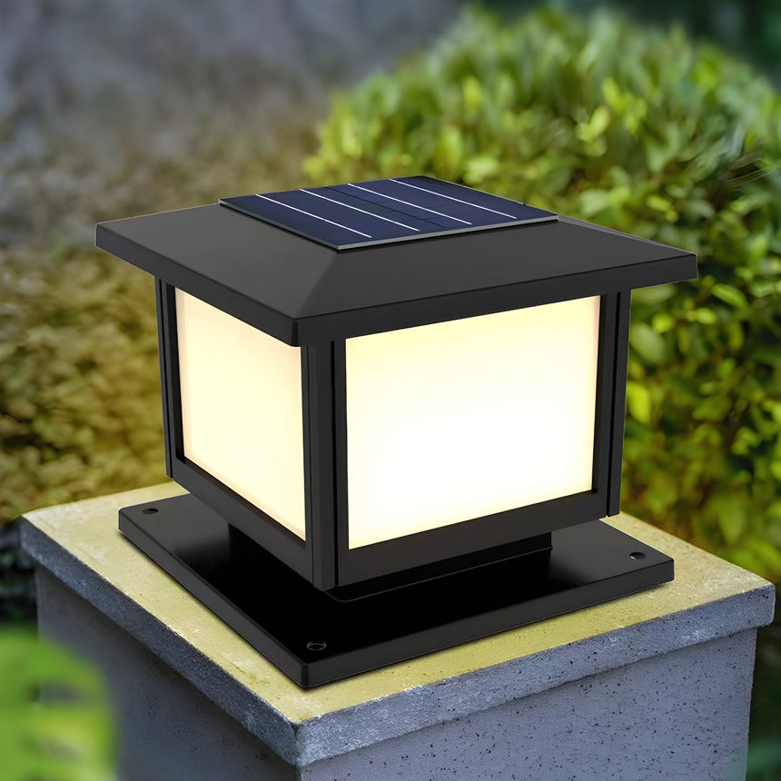 The panels glowing warm on a pillar with planting and a path behind