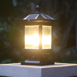 Warm light filling the ribbed glass on a pillar with a wall behind
