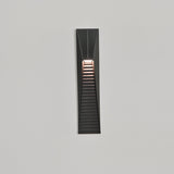 The light throwing bands of warm light down a pale render facade