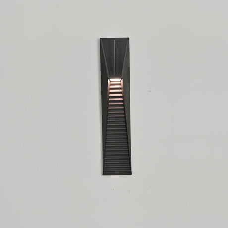 The light throwing bands of warm light down a pale render facade