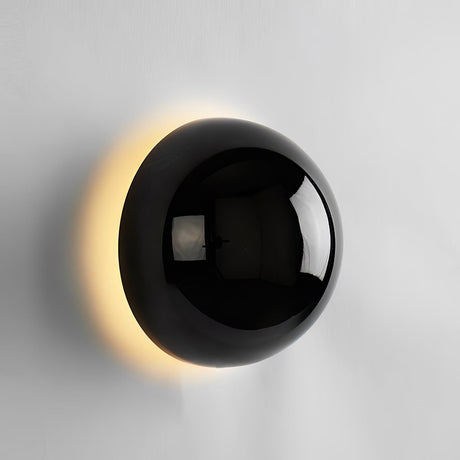 The black sphere lit, warm light around its edge