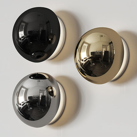 The three finishes, black, gold and chrome, side by side on a wall