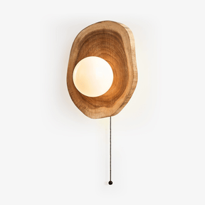Sphere wall sconce, a white sphere half sunk into an irregular wood slab