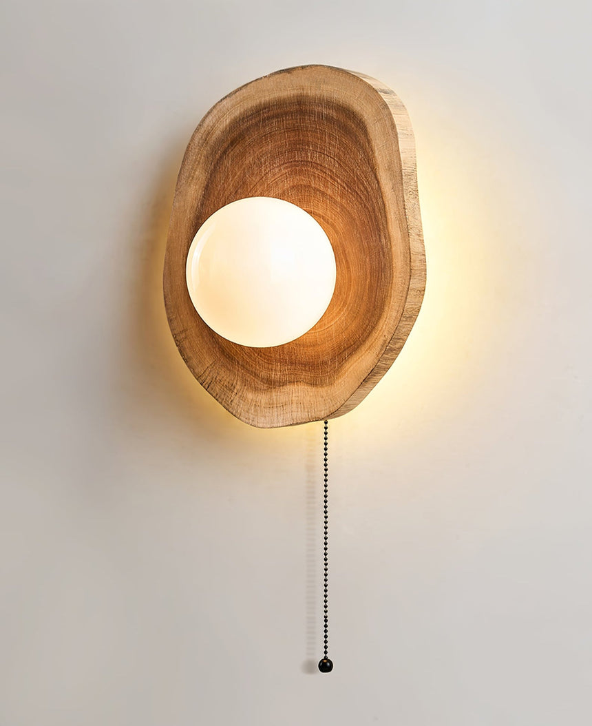 The wood slab unlit, the white sphere sitting in its hollowed opening