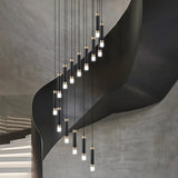 The spiral lit against a bare concrete wall above a flight of stairs