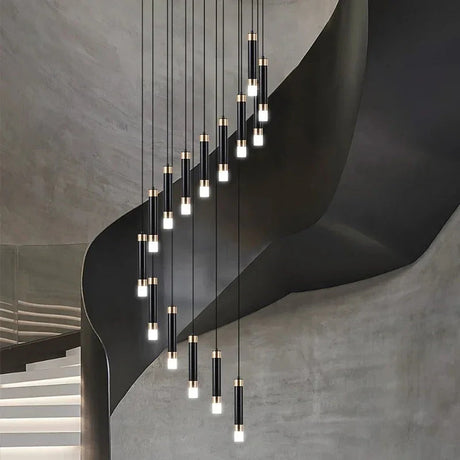 The spiral lit against a bare concrete wall above a flight of stairs