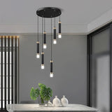 The cluster hung short above a dining table with vases on a sideboard behind