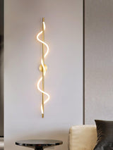 The lit spiral above a round table beside an armchair in a living room