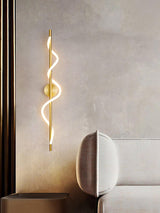 The lit spiral above a console with a rounded chair beside a sofa
