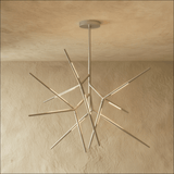 The same radiating form in chrome, each arm tipped with a lit segment