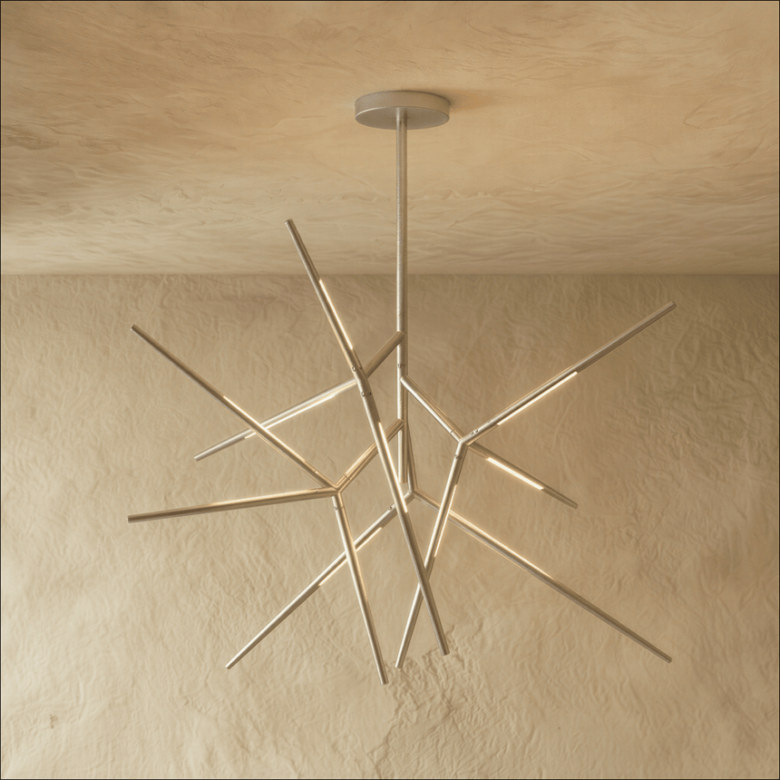 The same radiating form in chrome, each arm tipped with a lit segment