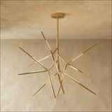 A gold sputnik chandelier whose lit arms radiate in every direction from one hub