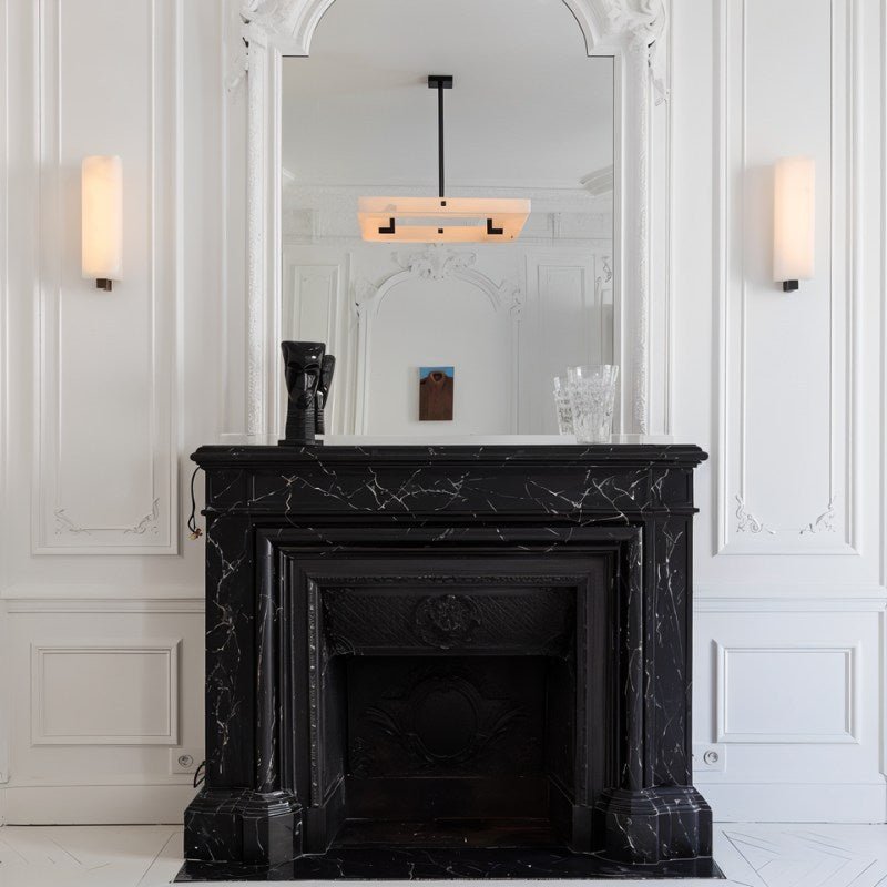 The lit square above a black marble fireplace with a mirror behind it
