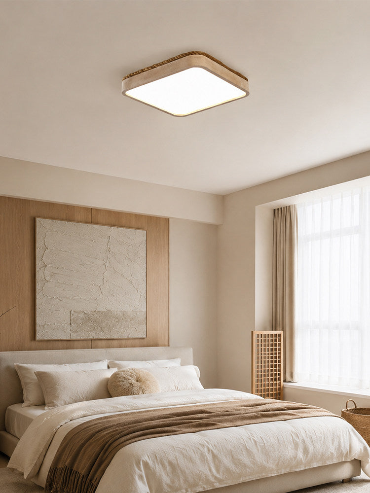 Square travertine ceiling light in a bedroom with a wood wall panel and a map print
