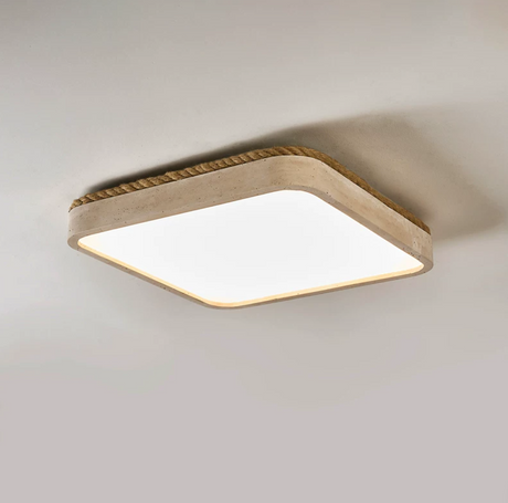 Square travertine ceiling light lit and seen from below at an angle