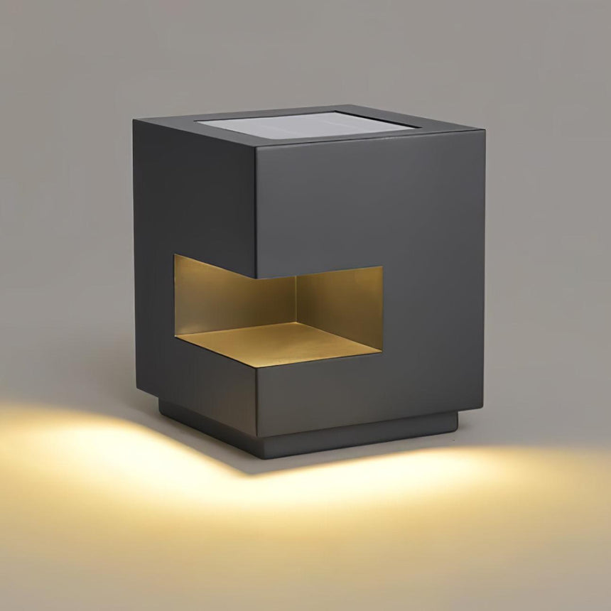 The slot glowing warm across the front of the cube, body unlit around it