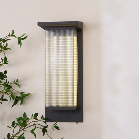 The lit lantern seen at an angle, the cap overhanging the ribbed body