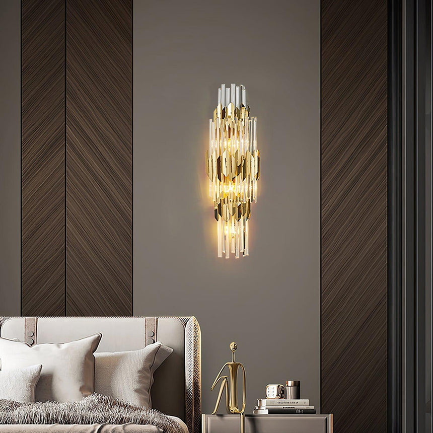 The sconce lit on a dark herringbone wall above a bed and a nightstand