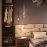 Single amber spindle lit beside a bed and an open wardrobe cabinet