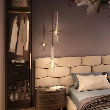 Single amber spindle lit beside a bed and an open wardrobe cabinet