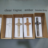 The four glass colors laid in open boxes and labeled clear to smoke gray