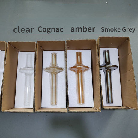 The four glass colors laid in open boxes and labeled clear to smoke gray
