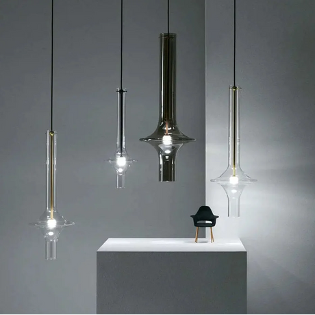 Three spindles hung at staggered heights in a dark lounge beside a low console